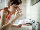 Bathtub Liner for Drinking Water Teenage Girl Drinking Water while Holding toothbrush In