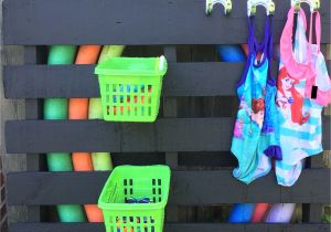 Do It Yourself Pool Float Rack Diy Pool toys Storage Painted Pallet Dollar Store Baskets and Hooks