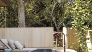 Freestanding Bathtub Garden A Serene Outdoor Bathing area Features A Barcelona Tub by