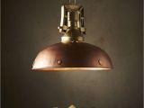 Hanging Lamps with Chain A Warm Copper Dome with Portholes Along the Rim Supported by A