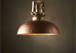 Hanging Lamps with Chain A Warm Copper Dome with Portholes Along the Rim Supported by A