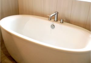 Oval Stand Alone Bathtub Wooden Laminate Flooring Idea with White Stand Alone