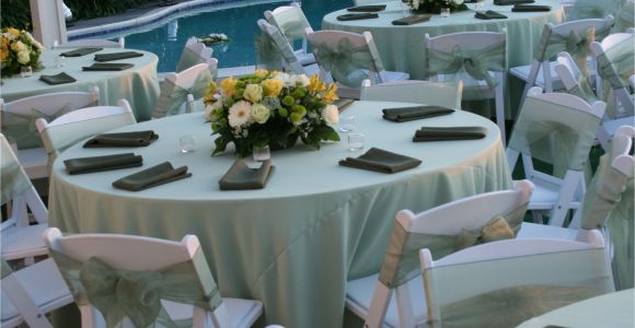 Renting Tables and Chairs for A Wedding Pastel Green Satin Table Cloths White Wood Padded Folding Chairs