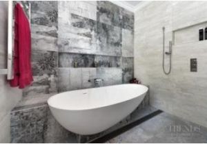 Semi Freestanding Bathtub Designer Tiles and A Semi Freestanding Tub are Features Of