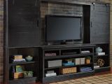 Sharlowe Entertainment Center with Wide Fireplace Insert Sharlowe Dark Finish Wall Unit with Bridge Piers W Barn Style Sliding Doors by Signature Design by ashley at Royal Furniture