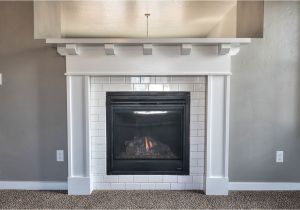 Using Quartz for Fireplace Surround Cozy Up to This Fireplace Surrounded with White Subway Tile and